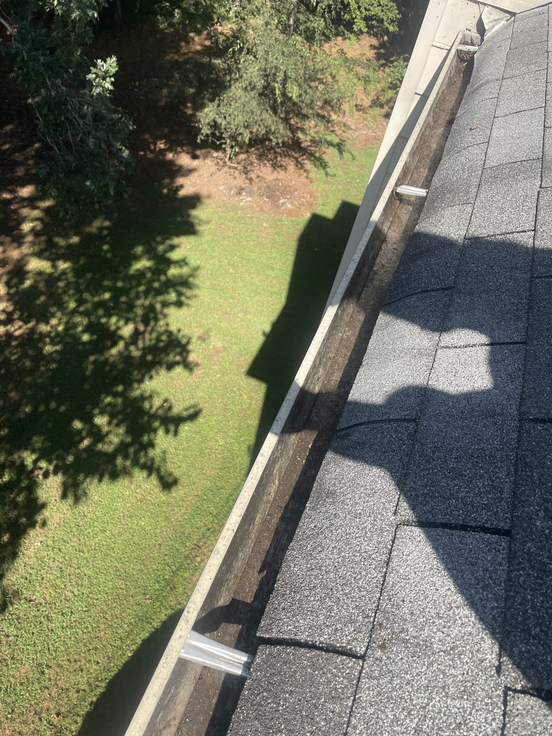 Debris built up along another section of the roofline gutter